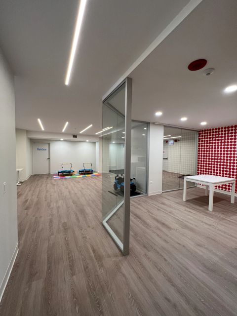 Frameless glass door between activity space and kitchen