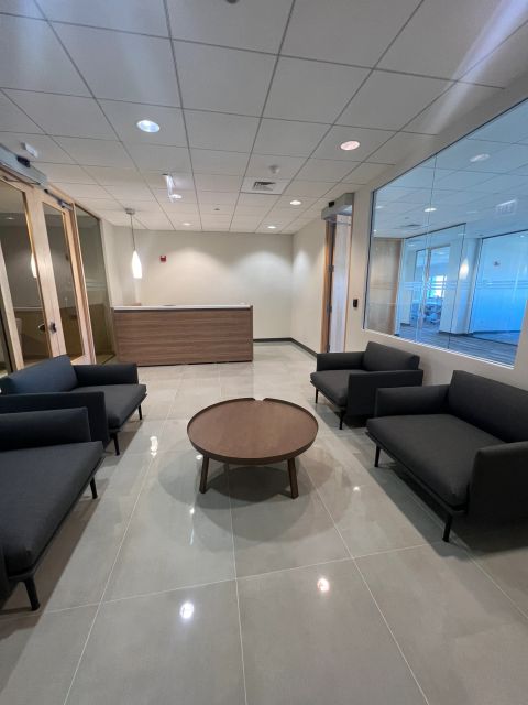 Reception lounge with dark sofas and round table