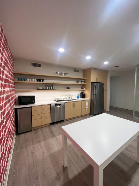 Kitchen with open shelves and red accent wall