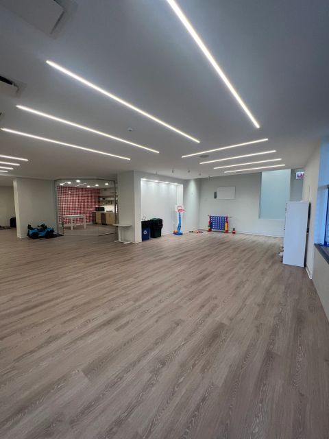 Open activity space with linear ceiling lights