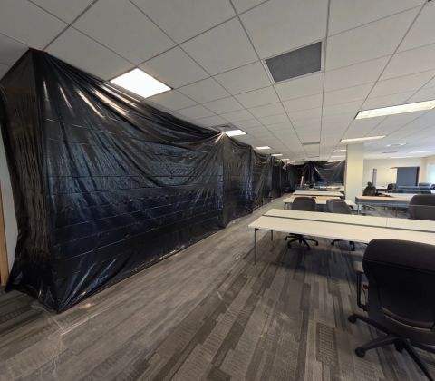 Protective dust barrier beside office workstations, in progress