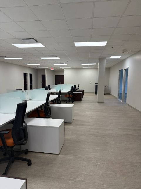 Open workplace with white desk benches