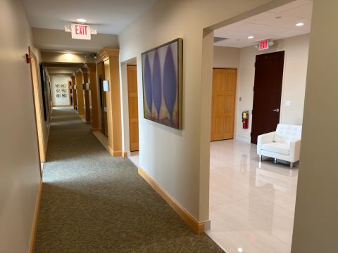 Reception corridor with artwork and wood doorways