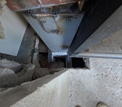 Close view of a welded repair at a steel column base