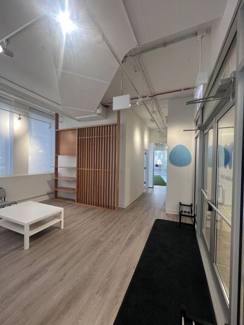 Waiting area with a wood slat divider and exposed ceiling